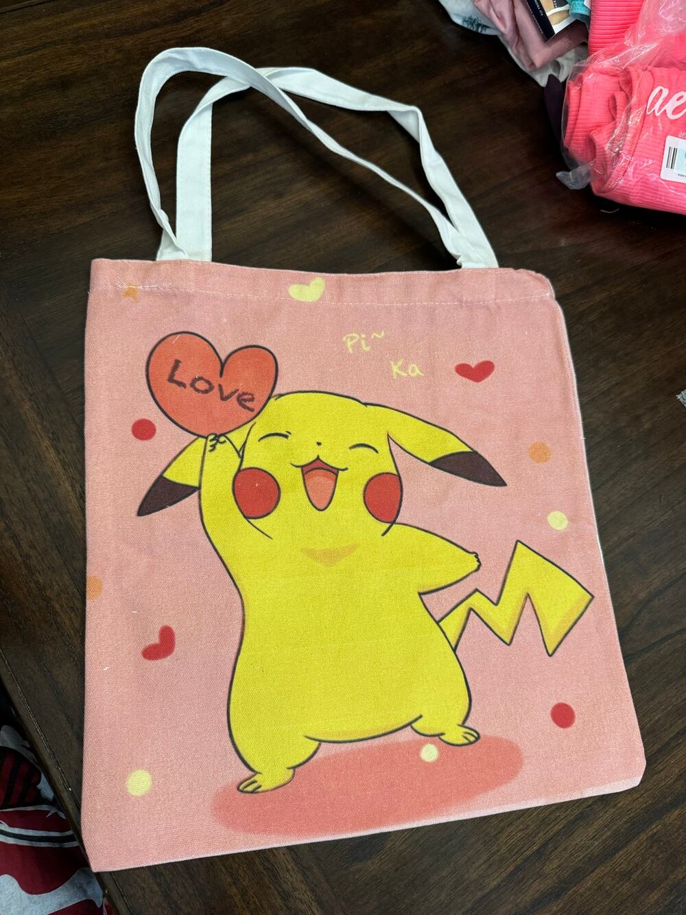 Pink Pikachu canvas tote bag with yellow Pikachu holding a heart-shaped balloon
